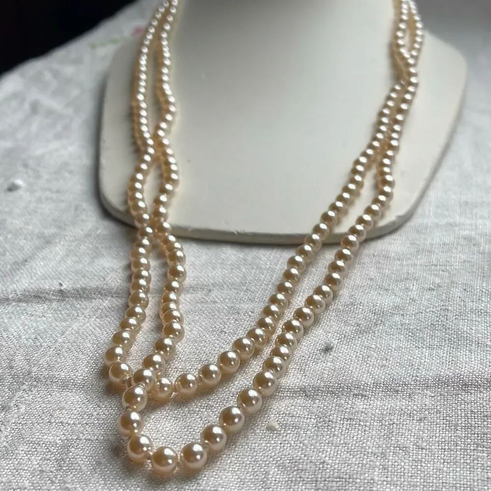 Vintage double strand hand knotted faux pearl necklace. Unknown